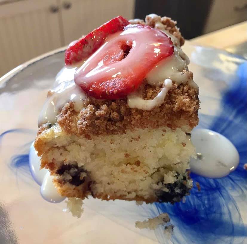 Our Maine blueberry sour cream coffee cake with strawberries and drizzled with a maple cream anglaise.